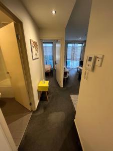 a room with a hallway with a room with a door at The One Grand Prix Living in Melbourne