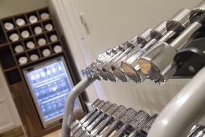 a bunch of wine glasses hanging from a rack at Thistle London Piccadilly in London