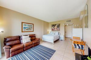 a living room with a couch and a bed at Pirates Bay A102 in Fort Walton Beach