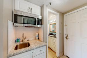 a kitchen with a sink and a microwave at Pirates Bay A102 in Fort Walton Beach