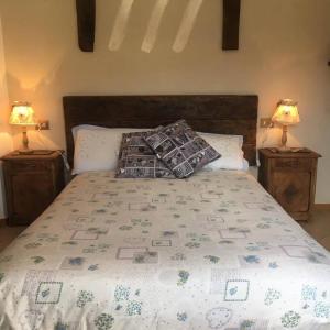 a bedroom with a bed with two lamps on tables at Casa dei nonni 