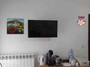 a flat screen tv hanging on a white wall at bed & breakfast Acquaviva di Vullo Vincenzo in Acquaviva Platani