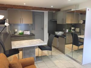 a kitchen with a table and chairs in a room at Orry d'Oriège in Ax-les-Thermes