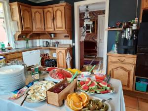 a table with many plates of food on it in a kitchen at Älgbergets Bed & Breakfast in Ucklum