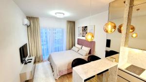 a hotel room with a bed and a mirror at Studio apartment Lora Lux - Bulevar in Sarajevo