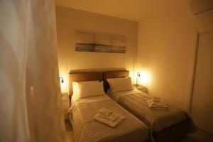 A bed or beds in a room at Santa Chiara Luxury House