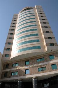 a tall building with the name alitaliaovo at Al Thill Hotel in Mecca
