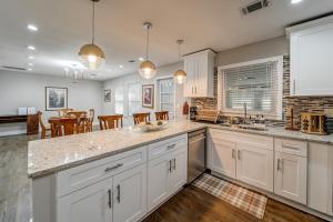 a kitchen with white cabinets and a dining room at East Point Elegance in Atlanta