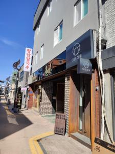 a building with a sign on the side of a street at Aha Stay in Gyeongju