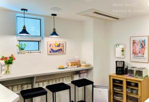 a kitchen with a counter and stools in a room at ARA125 in Seoul