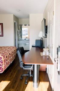 a hotel room with a desk and a bed at Exclusive Quarters in Cleveland