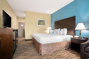 a hotel room with a bed and a flat screen tv at Best Western Ville Platte in Ville Platte +17 photos