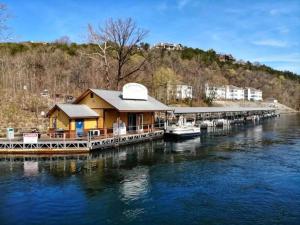 a house on a dock on the water at Sparkling Designer 3 bed Suite by Taneycomo in Branson