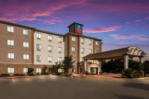a hotel with a clock tower on top of it at SureStay Plus Hotel by Best Western Near SeaWorld San Antonio in San Antonio