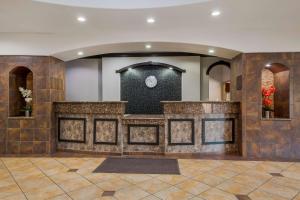 an empty lobby with a large stone counter top at SureStay Plus Hotel by Best Western Near SeaWorld San Antonio in San Antonio +37 photos