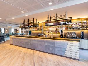 a bar in a restaurant with a counter at Novotel Liverpool Paddington Village in Liverpool