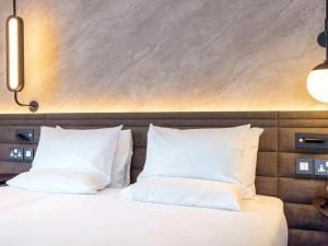 a bedroom with two white pillows on a bed at Novotel Liverpool Paddington Village in Liverpool