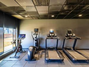 a gym with treadmills and ellipticals in a room at Novotel Liverpool Paddington Village in Liverpool