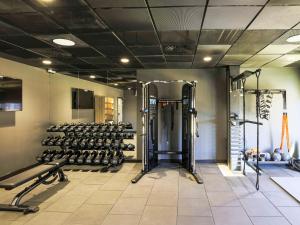 a gym with lots of treadmills and weights at Novotel Liverpool Paddington Village in Liverpool