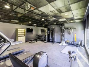 a gym with several treadmills and machines in it at Novotel Liverpool Paddington Village in Liverpool