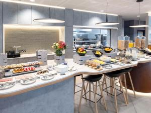 a kitchen with a counter with food on it at Novotel Liverpool Paddington Village in Liverpool