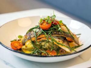 a white bowl filled with food on a table at Novotel Liverpool Paddington Village in Liverpool