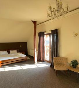 a bedroom with a bed and a chandelier at Victoria in Elblag