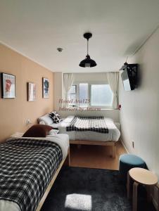 1 dormitorio con 2 camas y ventana en ARA125 en Seúl