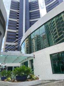 a tall building with some plants in front of it at Beach Class Fortaleza by AM in Fortaleza