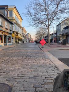 a cobblestone street with a red sign on it at monthly only shared apt in Newport