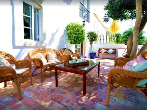 a patio with wicker chairs and a coffee table at Elegant villa with sea view in Loulé + private pool in Loulé +85 photos