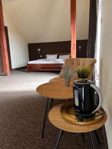 a hotel room with a coffee table and a bed at Victoria in Elblag