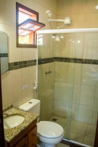 a bathroom with a shower and a toilet and a sink at MOANA b&b in Búzios