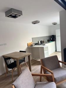 a living room with a table and chairs and a kitchen at Loft .Once de Abril in Bahía Blanca +4 photos