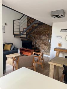 a living room with a couch and a staircase at Loft .Once de Abril in Bahía Blanca
