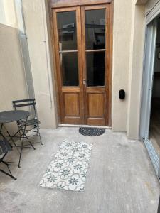 a wooden door with a rug in front of it at Loft .Once de Abril in Bahía Blanca