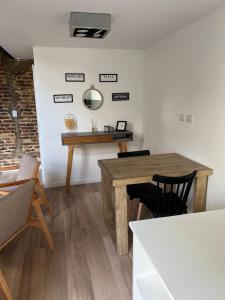 a dining room with a wooden table and chairs at Loft .Once de Abril in Bahía Blanca