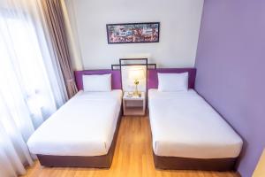 Postel nebo postele na pokoji v ubytování MPalace Hotel KL