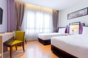 Postel nebo postele na pokoji v ubytování MPalace Hotel KL