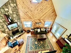 an overhead view of a living room with a stone wall at C13 - Forest View two bedroom, two bath Harbor North luxury loft cottage with private hot tub o Lake on Ouachita in Mount Ida