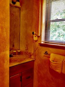 a bathroom with a sink and a toilet and a window at C13 - Forest View two bedroom, two bath Harbor North luxury loft cottage with private hot tub o Lake on Ouachita in Mount Ida