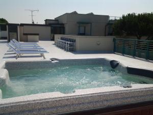 a swimming pool on the roof of a house at Hotel Flora in Marina di Bibbona