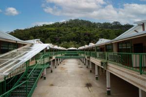 an empty train station with a mountain in the background at GH Hotel Express in Juiz de Fora