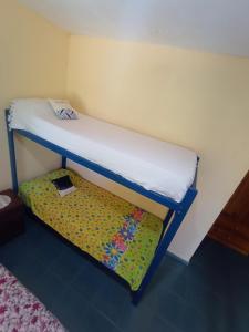 a small bedroom with a bunk bed with a platform at TU LUGAR in Villa Cura Brochero
