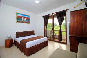 a bedroom with a bed and a window with a balcony at Natura Gardens Galápagos in Bellavista +53 photos