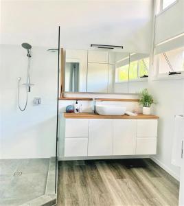 a bathroom with a sink and a shower at Pandanus Pocket 3BR Beachside Condo by uHoliday in Casuarina