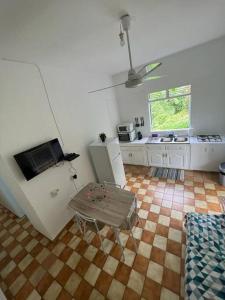 a kitchen with a table in the middle of a room at Charmante maison in Deshaies