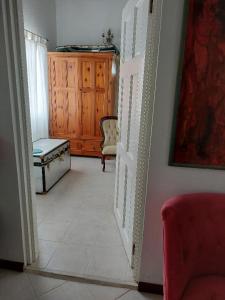 a living room with an open door and a chair at Selen's Apartment in Ti Rocher Micoud Saint Lucia in Micoud