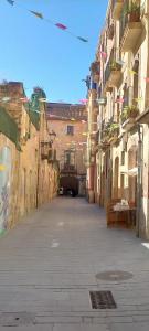 an empty alley with buildings and graffiti at Bonito y céntrico apartamento casco antiguo in Tarragona