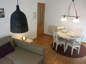 a living room with a couch and a table and chairs at Apartamento Bielsa-Monte Pérdido in Bielsa +22 photos